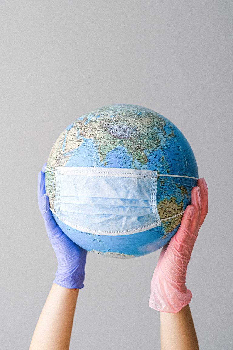 Globe wearing a protective mask because of travel pandemic.